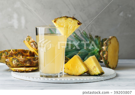 Pineapple fresh juice in glass on a wooden table 39203807