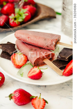Strawberry ice cream with chocolate on a stick. 39204060