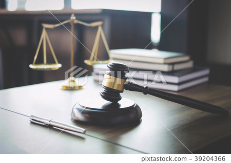Scales of justice and Gavel on wooden table and Lawyer or Judge Scales of justice and Gavel on wooden table and Lawyer or Judge 39204366