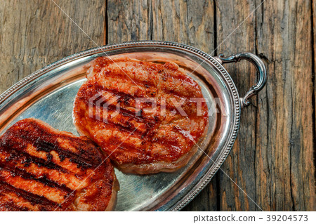 Grilled ribeye beef steak, herbs and spices. 39204573