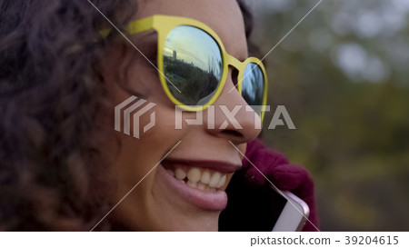 Closeup of biracial happy lady in sunglasses Closeup of biracial happy lady in sunglasses 39204615