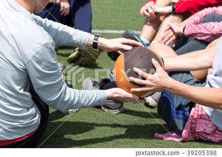 Athletes passing a medicine ball Athletes passing a medicine ball 39205398