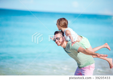 Little girl and happy dad having fun during beach 39205433