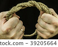 Braided coconut rope in the hands of men in 39205664