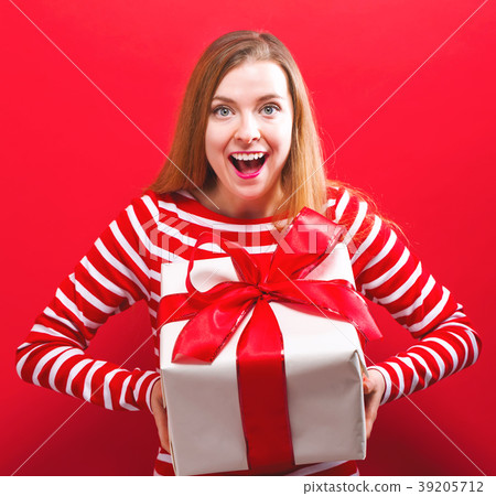 Happy young woman holding a gift box 39205712