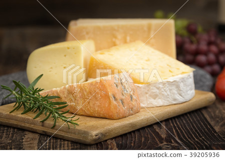 Cheeses with basil, rosemary, tomatoes and grapes. Cheeses with basil, rosemary, tomatoes and grapes. 39205936