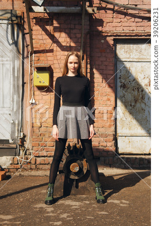 Pretty model posing on old factory backyard Pretty model posing on old factory backyard 39206231