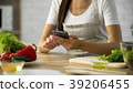Woman choosing salad recipe on smartphone at the 39206455