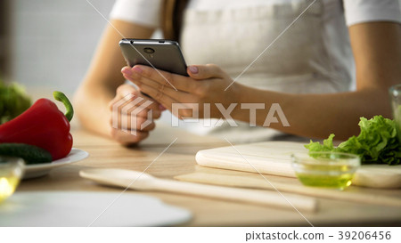 Close-up of female hands scrolling on smartphone Close-up of female hands scrolling on smartphone 39206456