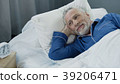Senior male waking up and smiling after 39206471