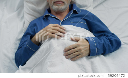 Male pensioner sweetly sleeping in bed, enjoying Male pensioner sweetly sleeping in bed, enjoying 39206472