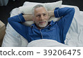 Man basking in bed rejoicing at new orthopedic 39206475