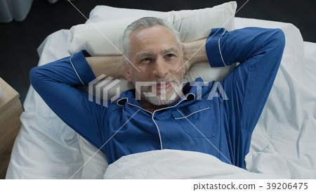 Man basking in bed rejoicing at new orthopedic 39206475