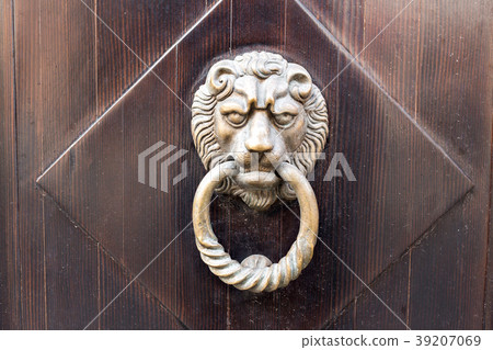 Old wooden door. Heads of lion on the front Old wooden door. Heads of lion on the front 39207069