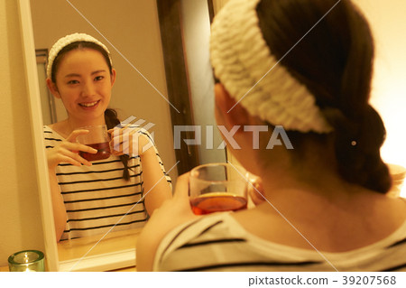 Taking care of beauty evening tea while drinking herbal tea 39207568