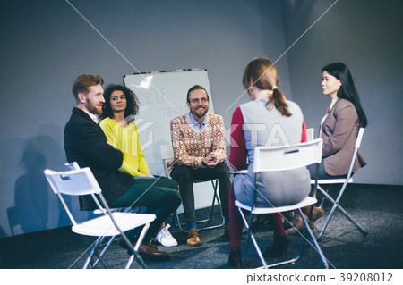 Large group of people having a counseling session. Large group of people having a counseling session. 39208012