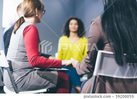 Group therapy session sitting in a circle 39208059