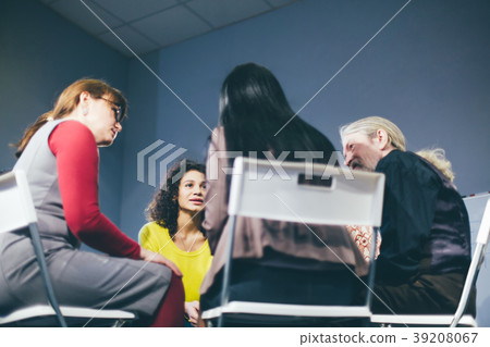 Group therapy session sitting in a circle 39208067