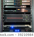audio equipment or controllers stacked in cabinet 39210984