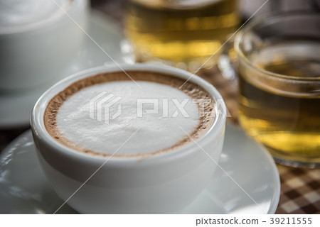 Coffee in cup on table with tea at coffee shop 39211555