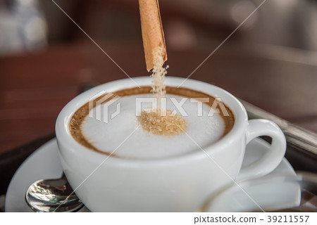 Pouring red sugar in to coffee at coffee shop Pouring red sugar in to coffee at coffee shop 39211557