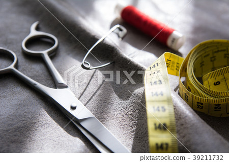 Yellow measuring tape, scissors and reel of red  39211732