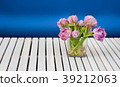 Purple tulips in the glass vase on the white 39212063