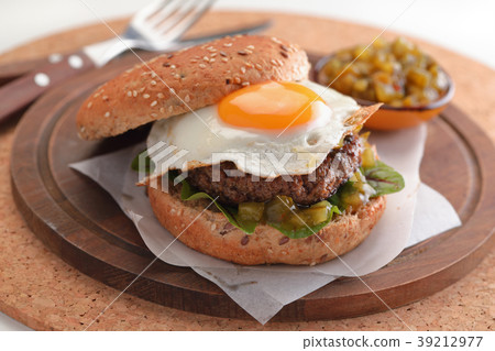 Hamburger with fried egg and gherkin salad Hamburger with fried egg and gherkin salad 39212977