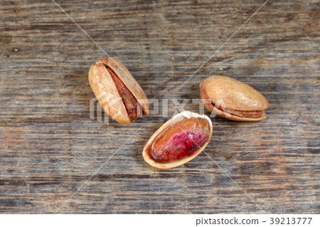 Pistachio nuts shell on rustic wood Pistachio nuts shell on rustic wood 39213777