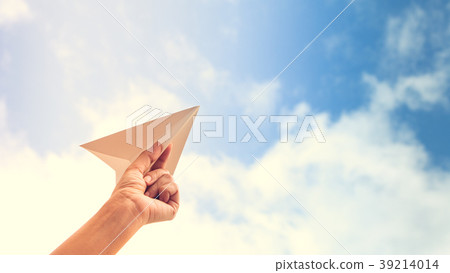 hand holding paper plane on sky background 39214014