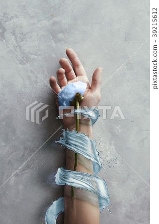 Hands with flowers with splash blue water in stone Hands with flowers with splash blue water in stone 39215612