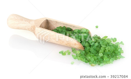 green bath salt in wooden spoon on white 39217084