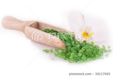 green sea salt in wooden spoon and flower on white green sea salt in wooden spoon and flower on white 39217085