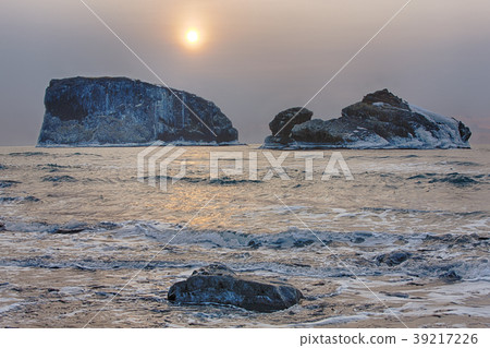 the harsh winter landscape morning ocean rocks. the harsh winter landscape morning ocean rocks. 39217226