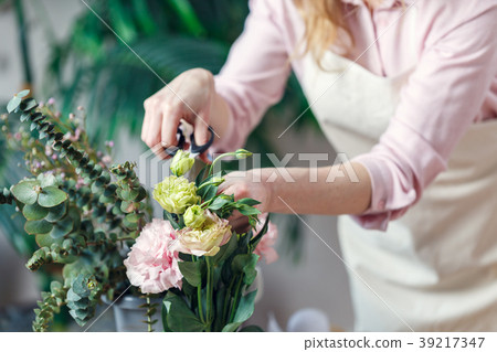 Portrait of florist woman with scissors with 39217347