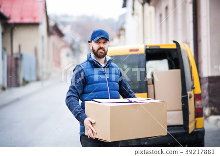 Delivery man delivering parcel box to recipient. 39217881