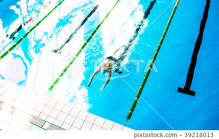 Senior man swimming in an indoor swimming pool. Senior man swimming in an indoor swimming pool. 39218013