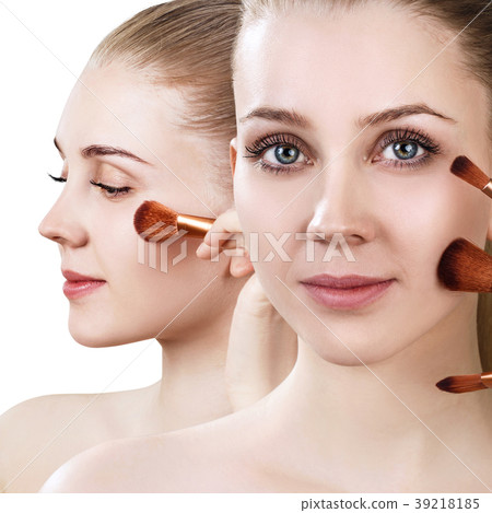 Beautiful woman holds makeup brushes near face. Beautiful woman holds makeup brushes near face. 39218185