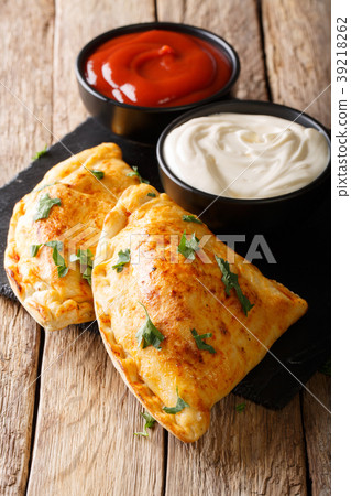 Crispy pizza calzone with meat and cheese 39218262