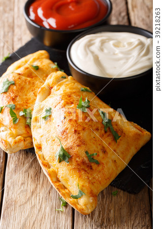 Delicious homemade pizza calzone with sauce Delicious homemade pizza calzone with sauce 39218263