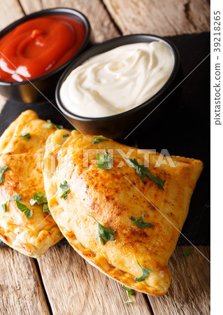 Italian traditional hot calzone with sauces Italian traditional hot calzone with sauces 39218265