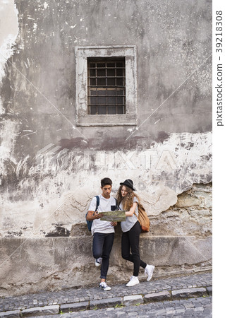 Two young tourists with a map in the old town. Two young tourists with a map in the old town. 39218308
