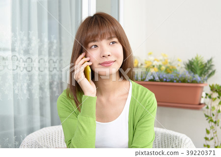 A woman talking on a smartphone 39220371