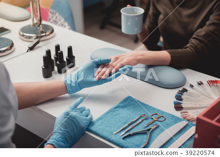 Manicurist arm creating nail correction 39220574