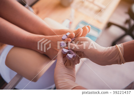 Woman arms having preparing visitor for pedicure 39221437