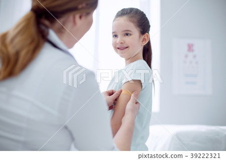 Female doctor giving patch to happy girl Female doctor giving patch to happy girl 39222321