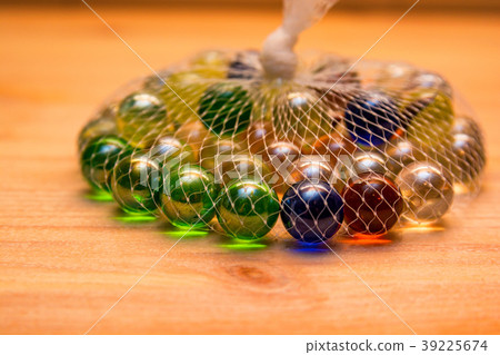 Colorful glass marbles in net 39225674