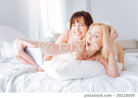 Nice female couple taking selfies Nice female couple taking selfies 39228089