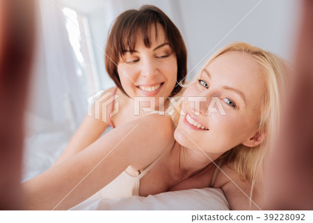 Beautiful blonde woman holding the camera Beautiful blonde woman holding the camera 39228092