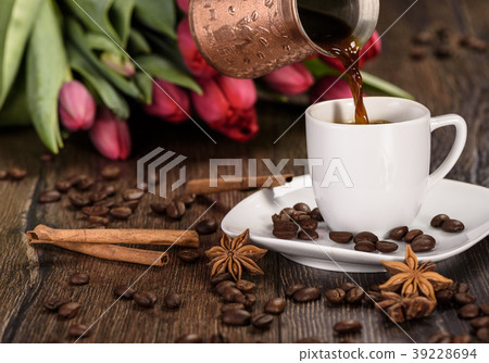 Pouring coffee from a jezveh through a cup of Pouring coffee from a jezveh through a cup of 39228694